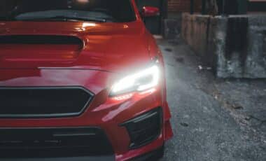 Red Car with Headlights ON