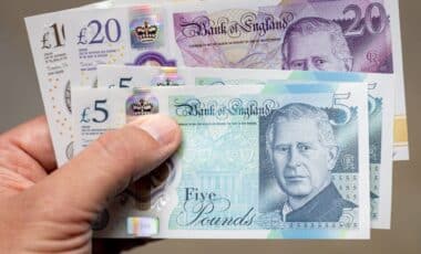 Hand Holding UK Bank Notes.