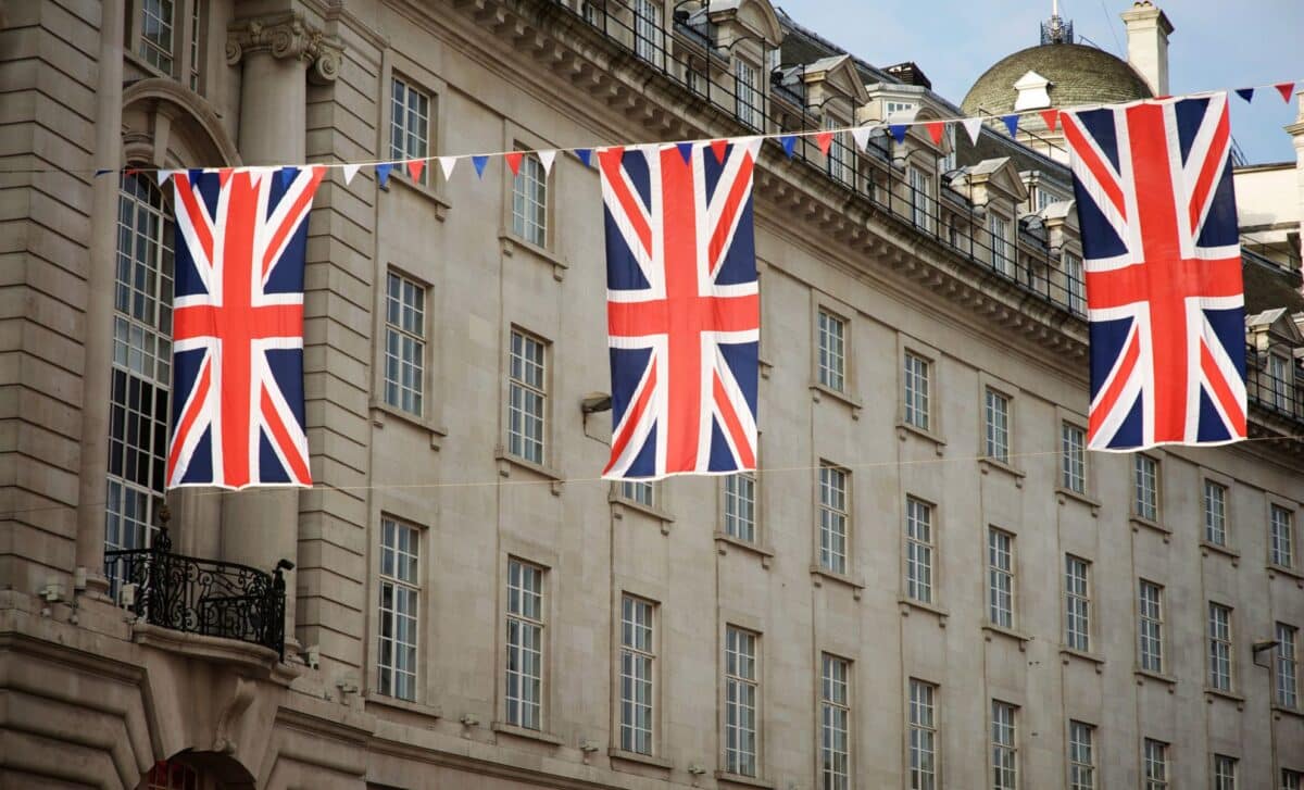 Union Jack Flags Strung In Front Of A Building to refer to UK Could See Extra Bank Holiday in 2025 with Plans for a Four-Day Weekend