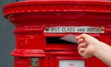 Man Hand Putting Letter in a Mail Box