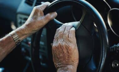 Hands, Senior Man and Steering Wheel in Car