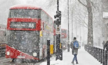 A Bus Stopped At A Stop Light In Camden Town. It Is A Winter Scene With Snow And Freezing Conditions.