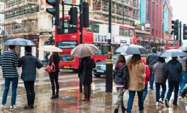 A Group Of People With Umbrellas In London During Rainy Weather.