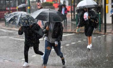 People Walking In A Rainy Weather While Holding Umbrellas