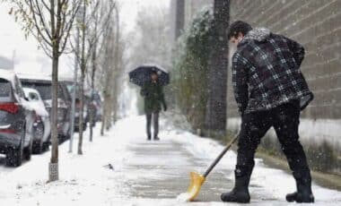 Arctic Blast : Snowy Weather With Man Shovelling Snow Outdoors.