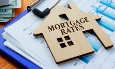 Mortgage Rates Sign On The House And Charts.