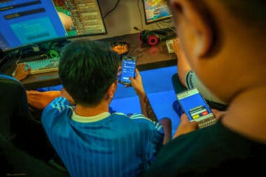 Players At A Crypto Gaming Internet Cafe Checking Their Crypto Wallets