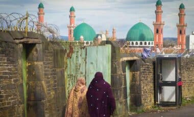 Two Muslim Women Walking Near A Mosque In Bradford.