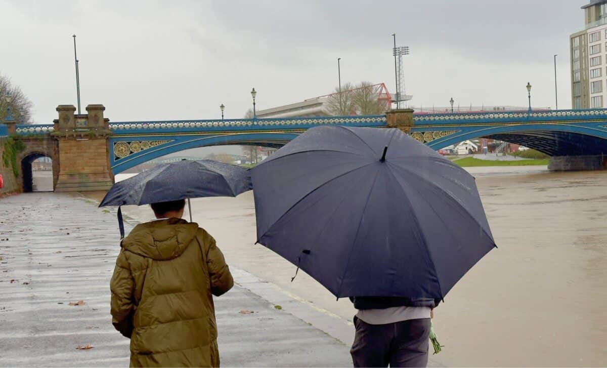 Two People On A Walk With Umbrellas In Rainy Weather