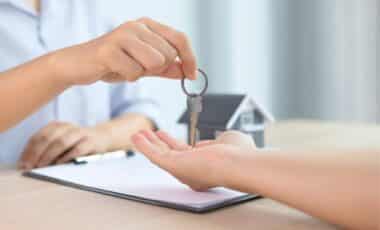 Housing Crisis - Estate Agent Giving The House Key To A Customer