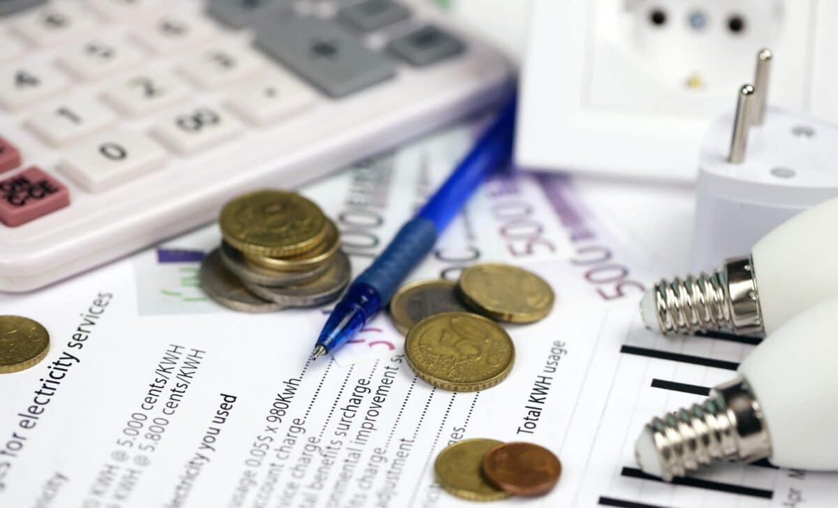 Calculator and Euro Bills with Pen on Electricity Bill to Symbolize Scottish Power Refund