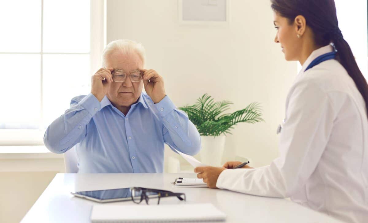 State Pension Old Man Trying On Glasses At A Doctor's Office