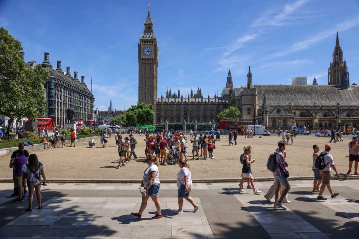 Tourists Crossing The Dried Up Parliament Square Near The Houses Of Parliament In London, United Kingdom, On 14 July.