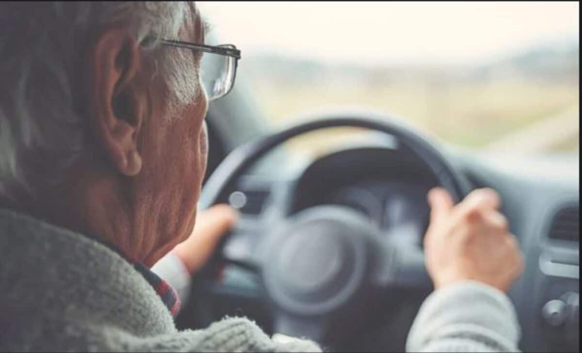 Old Man In A Car With Hands On Steering Wheel