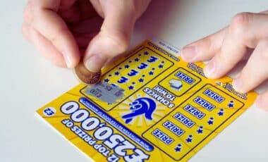 Scratching A National Lottery Scratch Lotto Card, England, Uk.