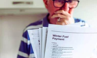 An Elderly Woman Holding Bills That Appear To Be Related To Information About Winter Fuel Payments.