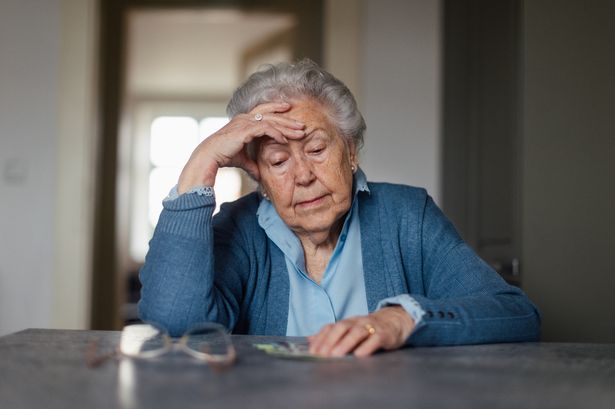 Old Lady Counting Money And Feeling Sad