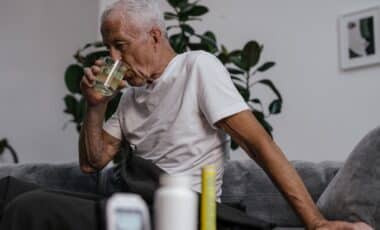 Older Man Drinking Water, Possibly Indicating Fatigue A Common Health Condition In Older Adults