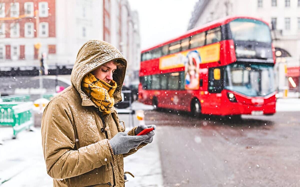 A Person Standing Next To The Road In A Cold Winter Weather