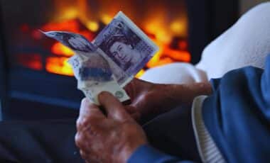 An Elderly Person's Hands Holding Two British £20 Notes, Symbolizing The Receipt Or Management Of Their State Pension.