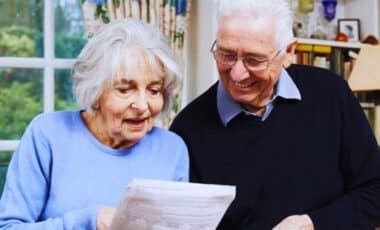 Elderly Couple In Front Of A Payment Notice