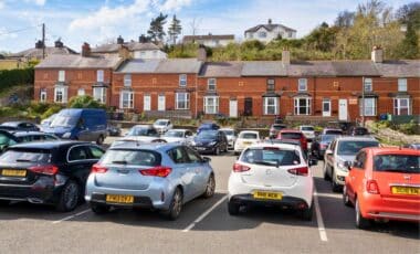 Houses In Menai Bridge, Anglesey, Wales, Uk, Overlooking A Cars Park.