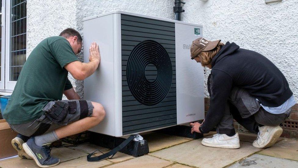 Boiler-heat-Technicians Installing A Heat Pump Outside A Residential Home