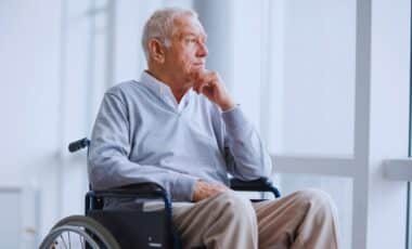 A Photo Of An Elderly Man With Health Conditions Seated In A Wheelchair.