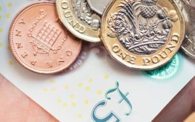 Cost of Living-One Pound Coins and Pennies on a Banknote