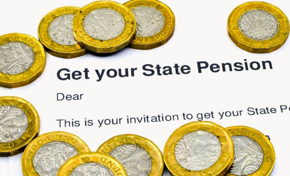 One Pound Coins On A Letter Inviting A Claim For State Pension