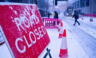 Road closed sign in Birmingham city during heavy snowfall in Birmingham