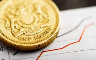 A one-pound coin on an upward graph, symbolising wage growth.