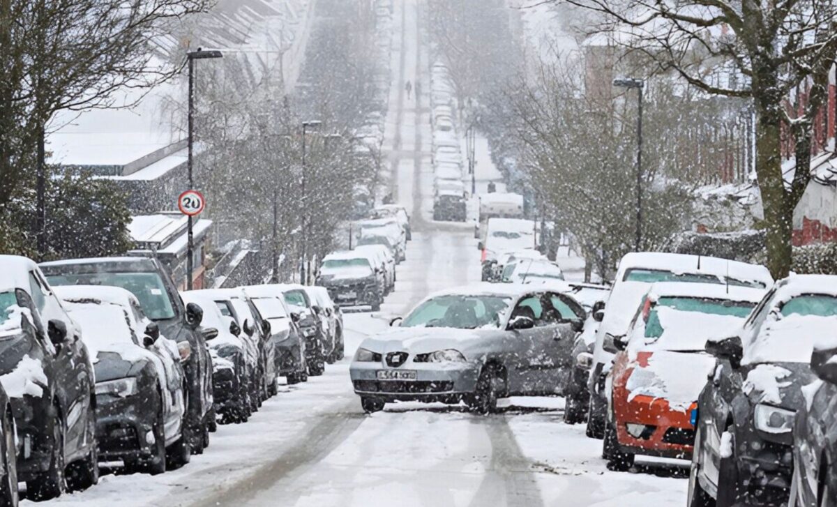 Weather Warning — A Car Performing Parallel Parking Manoeuvre Under Snowstorm