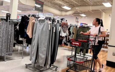 a shopper pushing a shopping cart inside a TJ Maxx retail store