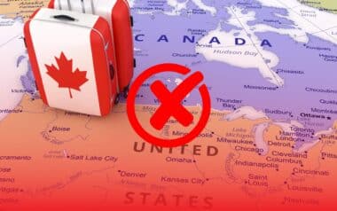 A map showing Canada and the United States and a bold red cross symbol over the U.S.