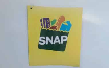 SNAP (Supplemental Nutrition Assistance Program) logo on a yellow background