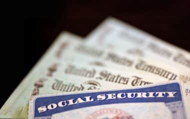 a Social Security card placed over several United States Treasury checks