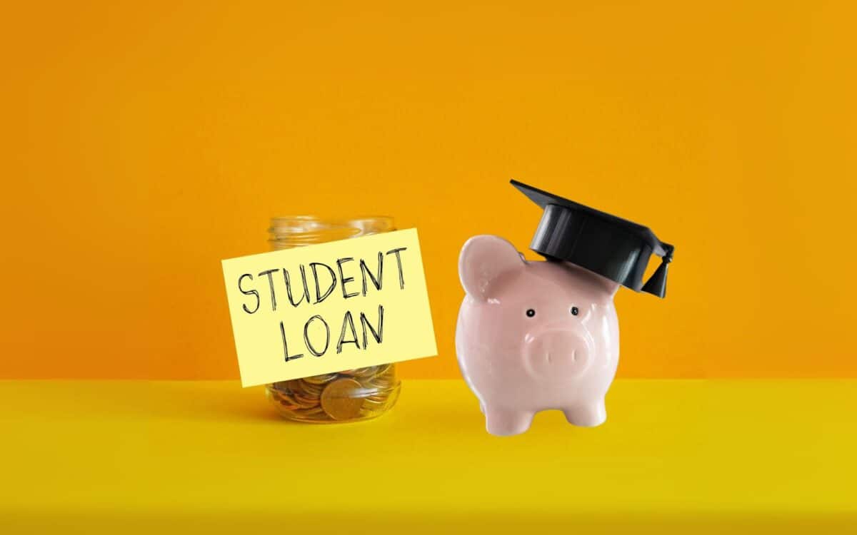 Piggy bank with graduation cap beside a jar labeled Student Loan
