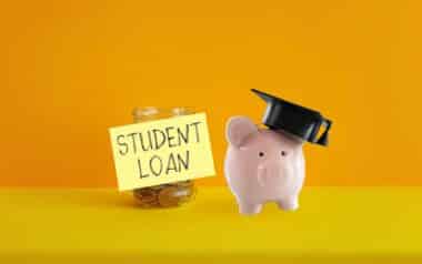 Piggy bank with graduation cap beside a jar labeled Student Loan