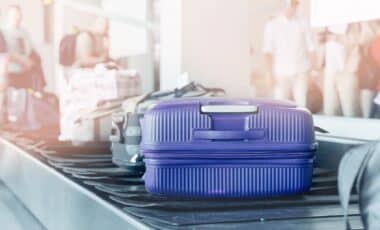 Blue suitcase on airport carousel