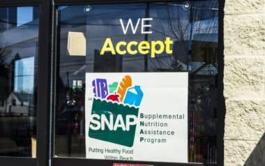 Shop window sign showing SNAP acceptance for food purchases.