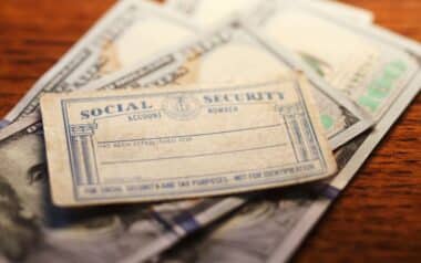 Social Security Card On Top Of Pile Of Money