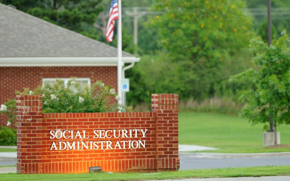 Social security administration sign illuminated with flag