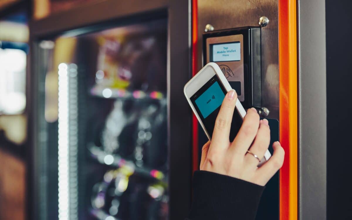 Woman Paying for Product at Vending Machine Using Smartphone