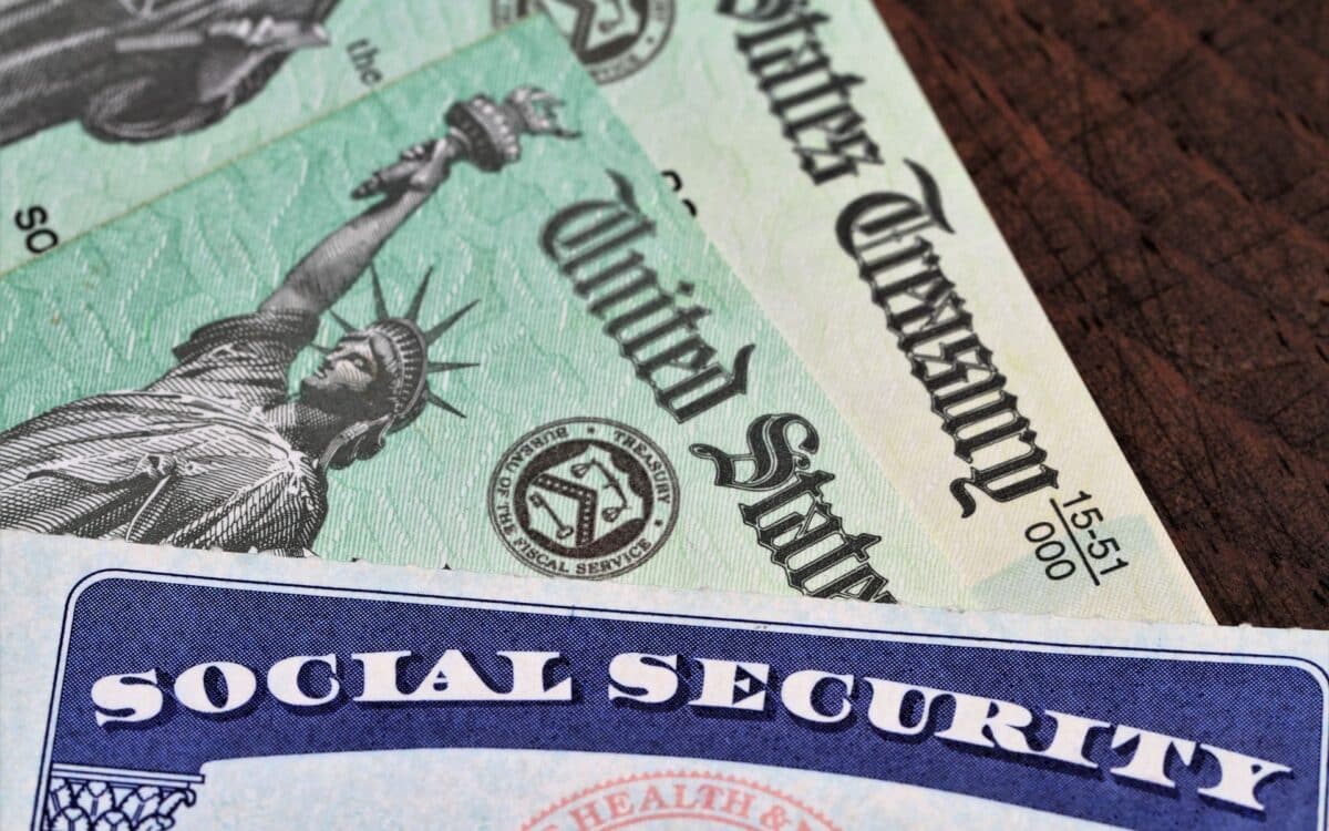 Social Security card overlapping two Treasury checks