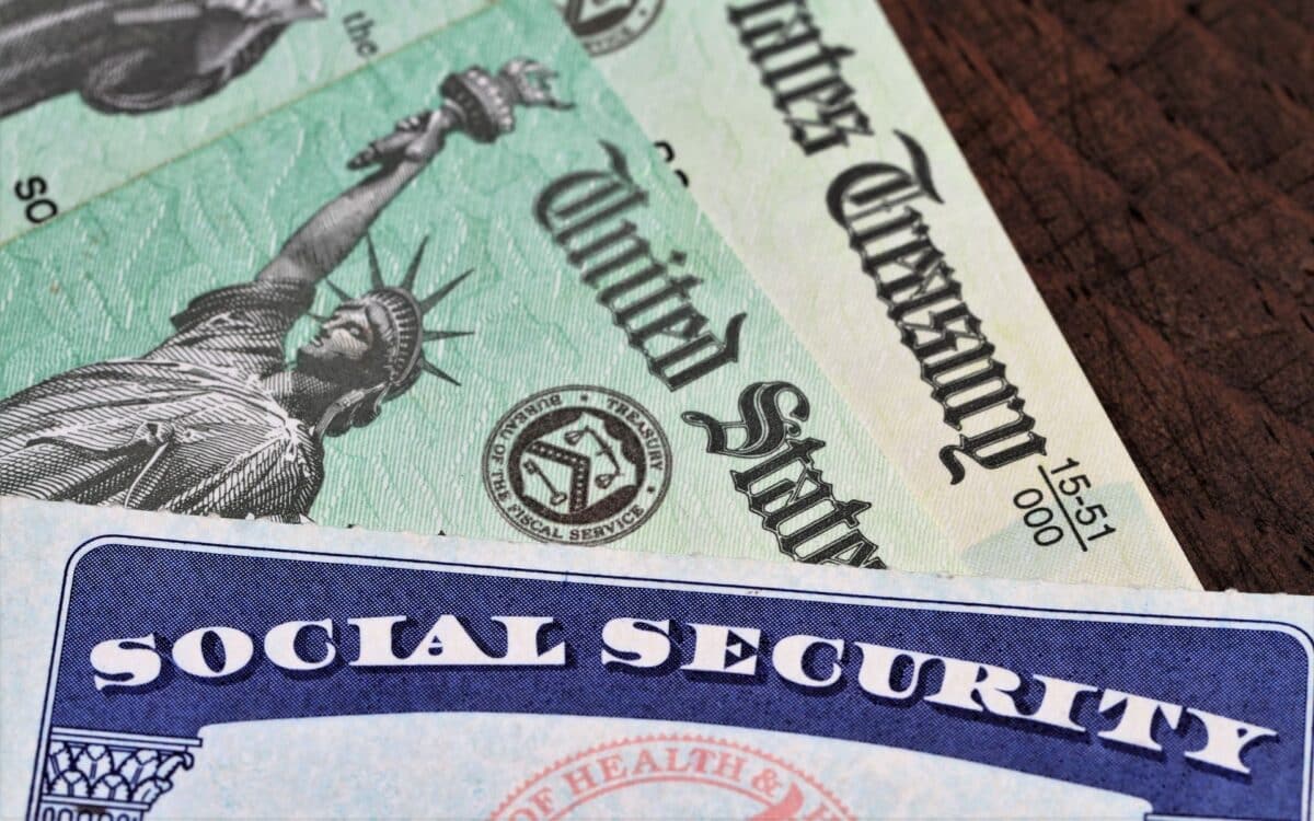 Social Security card overlapping two Treasury checks