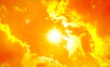 Sun shining through orange skies