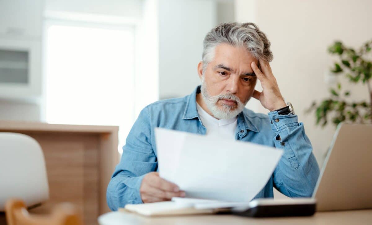 Frustrated older man reading a document