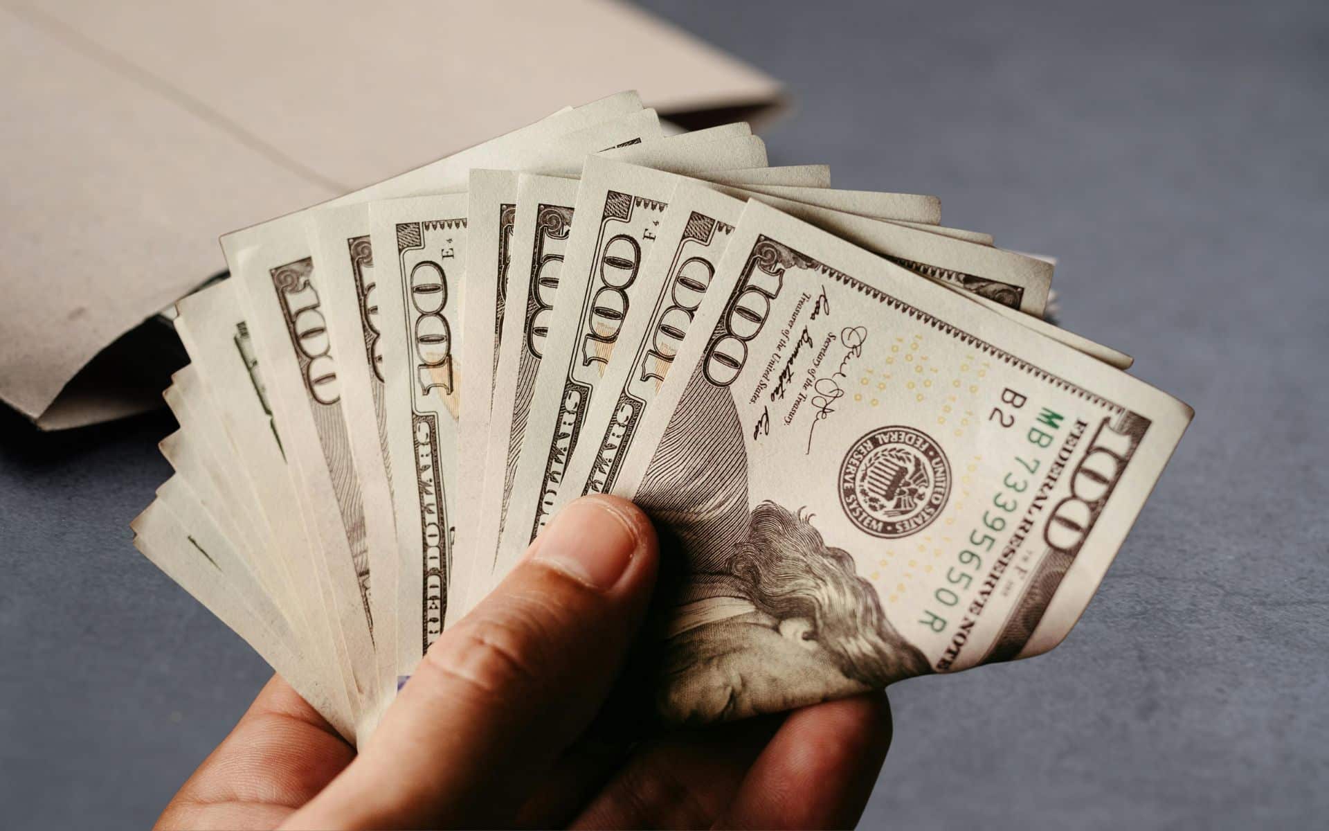 Hand Holding Dollar Bills
