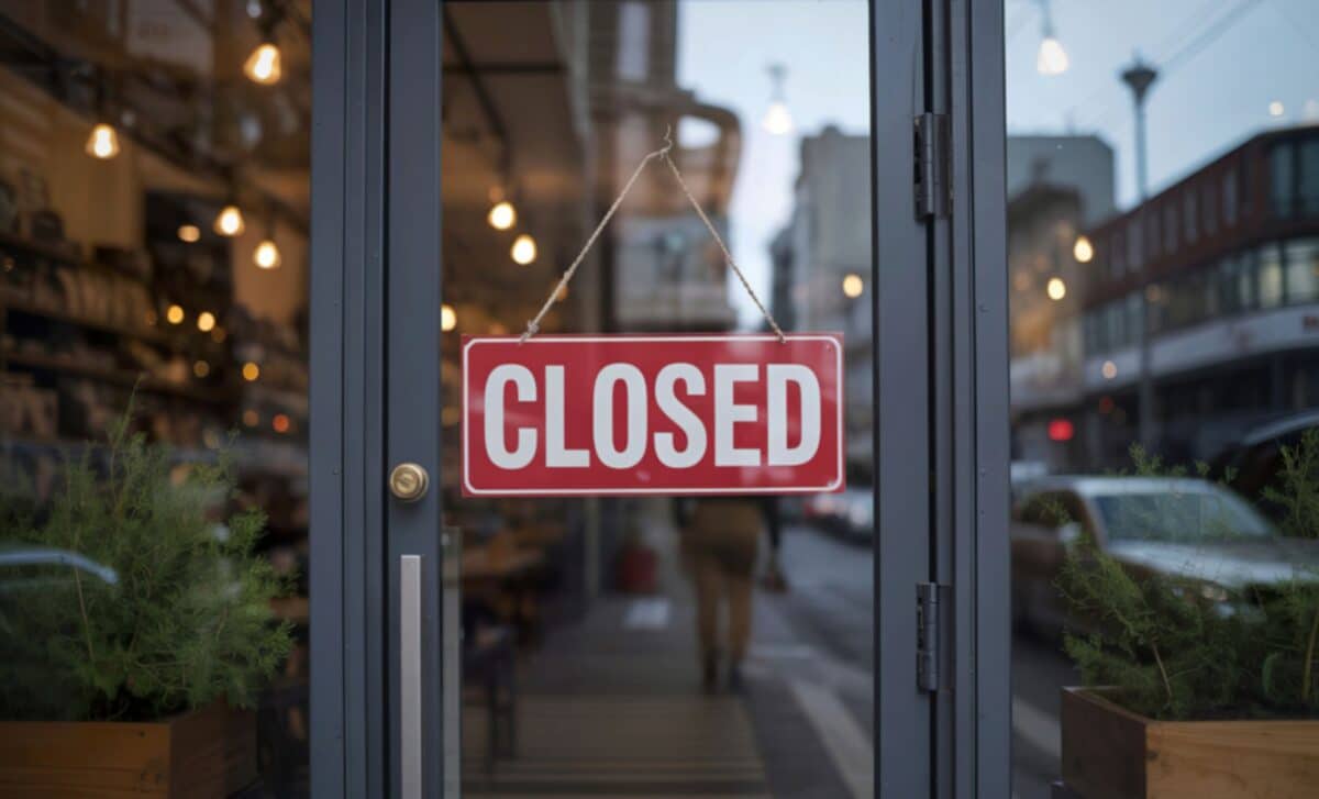 A red and white closed store sign